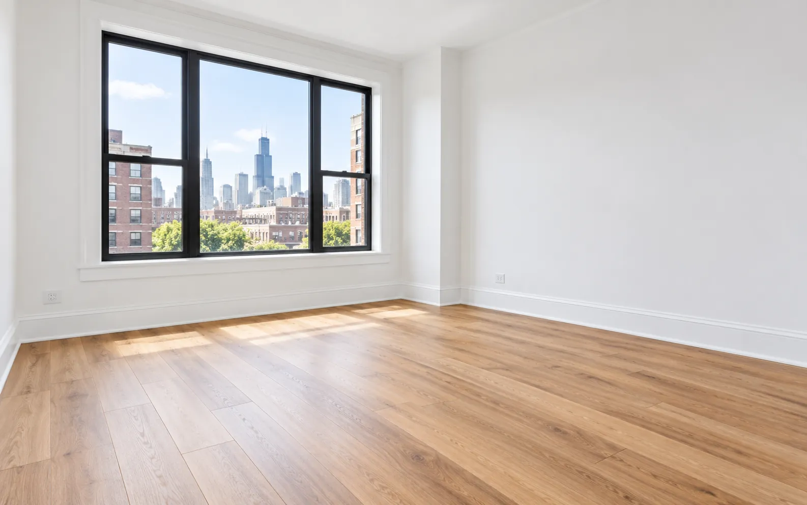 A bright room with new luxury vinyl plank flooring and a skyline view